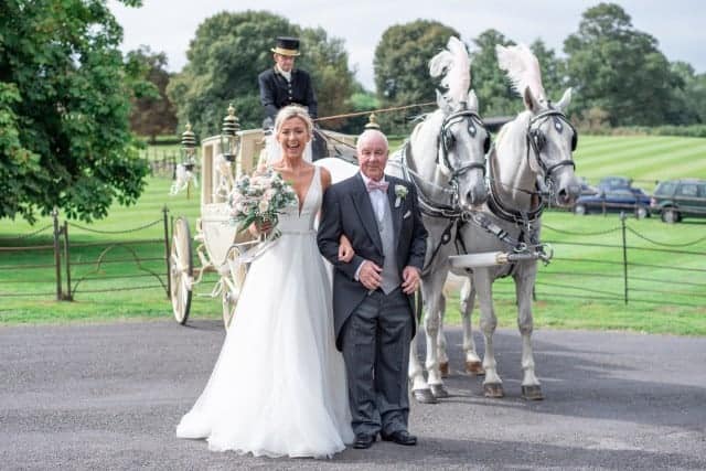 rosie daniels bride with father in front of horse and carriage
